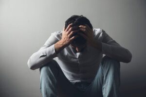Man experiencing distress illustrating the emotional and physical toll of substance abuse addiction