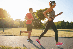 Man and woman exercising outdoors together during detox recovery