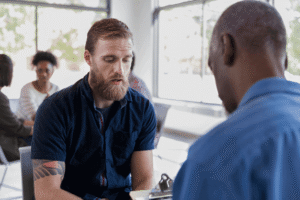 Man talking one-on-one with a counselor about his level of care