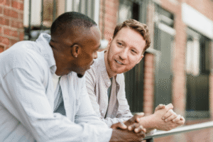 Close-up of two men in a supportive one-on-one conversation