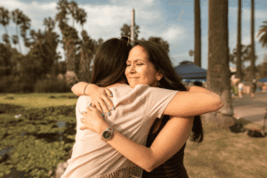 Two women embracing in a moment of emotional support and encouragement