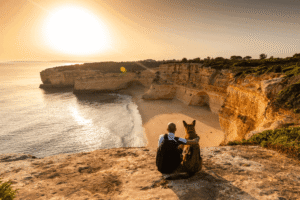 Man sitting outdoors with his dog during addiction recovery