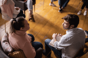 Two people talking during a supportive group therapy session