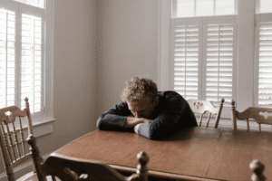Man sitting alone on a chair, reflecting after a relapse