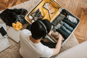 Man packing a suitcase as he prepares to move into a sober living home