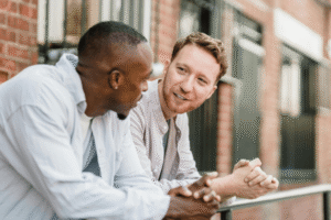 Two men having a supportive, honest conversation about being in recovery