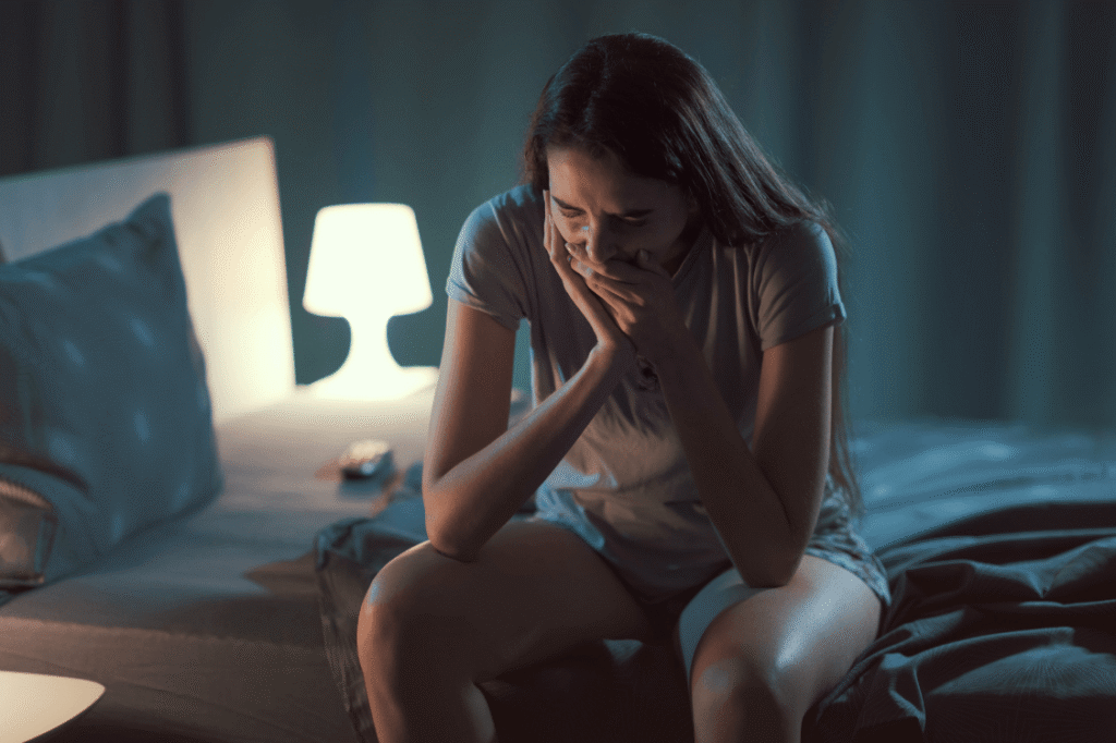 Distressed woman sitting alone, reflecting the emotional struggle of borderline personality disorder and addiction