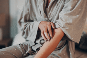 Person anxiously picking at their skin, a common sign of OCD-related stress